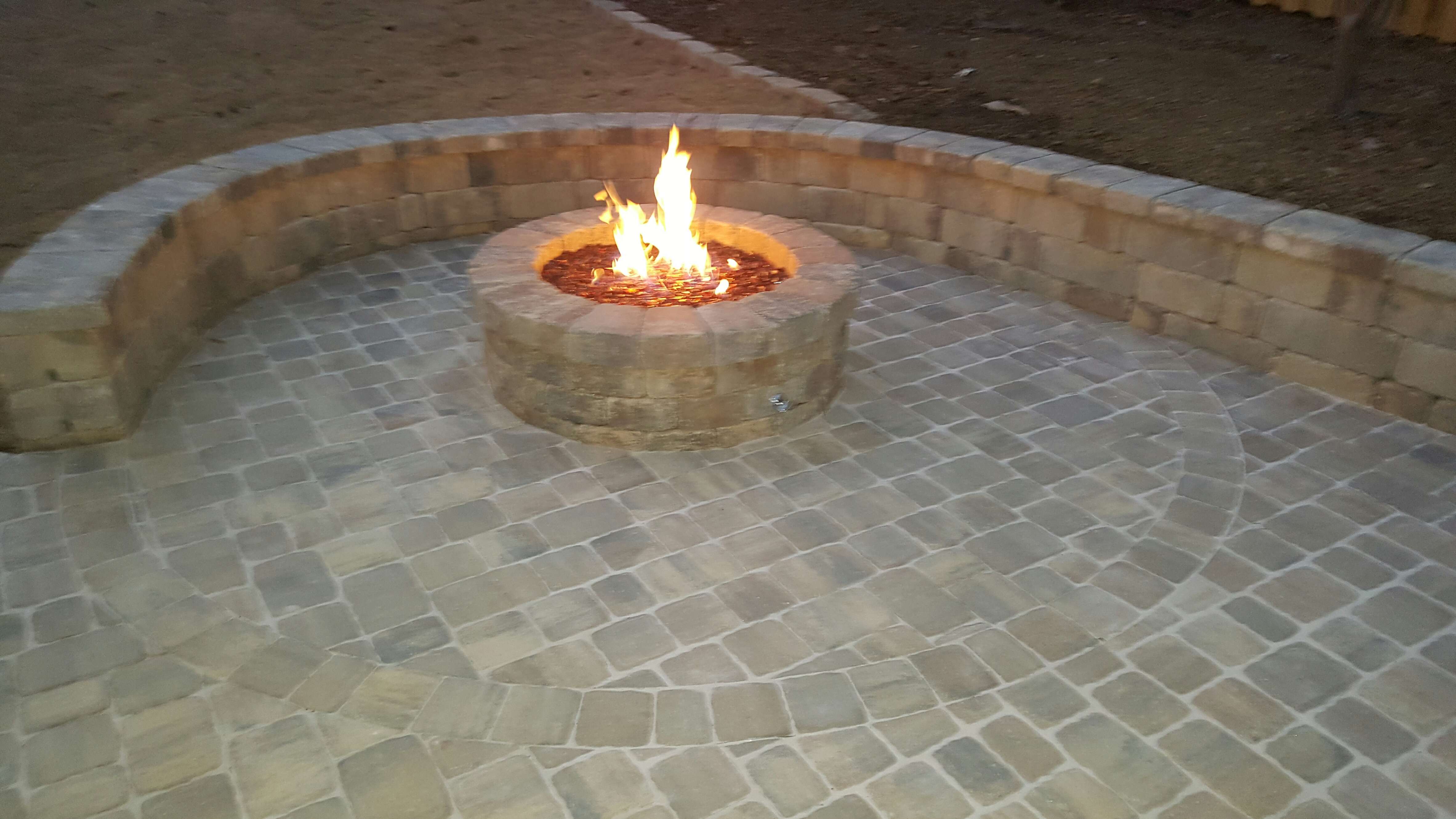 Paver patio with stone sitting wall and fire pit. 